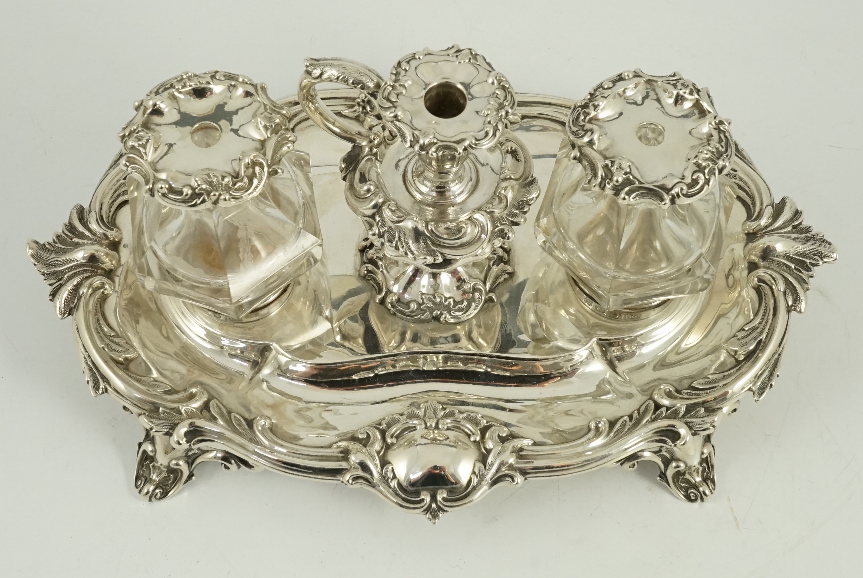An ornate Victorian silver oval inkstand, by Henry Wilkinson & Co